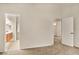 Spacious bedroom with neutral carpet, adjacent bathroom with wood cabinets, and additional room access at 21721 Loch Haven Pass, Leesburg, FL 34748