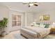 Bright bedroom features neutral walls, plush carpet, and a king bed with stylish lamps at 21721 Loch Haven Pass, Leesburg, FL 34748