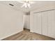 Neutral bedroom featuring plush carpeting, a ceiling fan, and a large closet at 21721 Loch Haven Pass, Leesburg, FL 34748