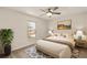 Comfortable bedroom featuring neutral walls, carpet, a ceiling fan, and a king bed at 21721 Loch Haven Pass, Leesburg, FL 34748