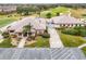 Aerial view of clubhouse with adjacent parking lot and golf course at 21721 Loch Haven Pass, Leesburg, FL 34748