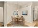 Dining room features a wooden table, seating for four, and decorative wall art at 21721 Loch Haven Pass, Leesburg, FL 34748