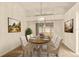 Dining room with a large table, seating for six, and decorative wall paintings at 21721 Loch Haven Pass, Leesburg, FL 34748