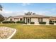 Single-story house with well-maintained lawn at 21721 Loch Haven Pass, Leesburg, FL 34748