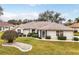 Single-story home with landscaped lawn and attractive curb appeal at 21721 Loch Haven Pass, Leesburg, FL 34748