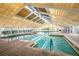 Indoor heated pool with skylights and brick deck at 21721 Loch Haven Pass, Leesburg, FL 34748