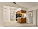 Open floor plan view of the kitchen with breakfast bar and sliding door to lanai at 21721 Loch Haven Pass, Leesburg, FL 34748