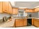 The kitchen features wood cabinets, granite countertops, and modern appliances at 21721 Loch Haven Pass, Leesburg, FL 34748