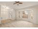Bright living room with neutral carpeting, bay windows, and a ceiling fan at 21721 Loch Haven Pass, Leesburg, FL 34748