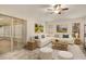 Living room with large sectional sofa, neutral colors, and sliding glass doors to Florida room at 21721 Loch Haven Pass, Leesburg, FL 34748