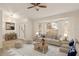 Bright living room with neutral tones, large window, ceiling fan, and stylish furniture at 21721 Loch Haven Pass, Leesburg, FL 34748