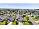 Aerial view of neighborhood with houses and palm trees at 2214 Quinn Ln, The Villages, FL 32162