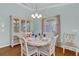 Bright dining room with hardwood floors and china cabinet at 2214 Quinn Ln, The Villages, FL 32162