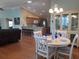 Inviting dining area with a white table set for four and a beautiful china cabinet at 2214 Quinn Ln, The Villages, FL 32162