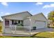 Front view of a house with white fence and double garage at 2214 Quinn Ln, The Villages, FL 32162