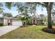 Beautiful one-story home with a paved driveway and lush landscaping at 2334 Fenton Ave, Clermont, FL 34711