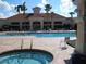 Community pool and spa with lounge chairs at 2334 Fenton Ave, Clermont, FL 34711