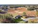 Aerial view of a house on a large lot with a neighborhood in the background at 238 Oak Lane Cir, Ocala, FL 34472