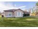 Single-story house with a brown roof, tan exterior, and a neatly landscaped lawn at 238 Oak Lane Cir, Ocala, FL 34472