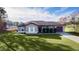 Single-story house with a brown roof, tan exterior, and a neatly landscaped lawn at 238 Oak Lane Cir, Ocala, FL 34472