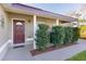 Front porch with white columns, two chairs, and neatly trimmed shrubs at 238 Oak Lane Cir, Ocala, FL 34472