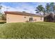 Tan house with red trim and large yard at 238 Oak Lane Cir, Ocala, FL 34472