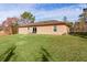 Tan house with red trim and large yard at 238 Oak Lane Cir, Ocala, FL 34472