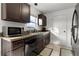 Modern kitchen with dark wood cabinets, granite countertops, and stainless steel appliances at 238 Oak Lane Cir, Ocala, FL 34472