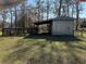 Metal shed with attached shelter and fenced area at 2403 County Road 416N, Lake Panasoffkee, FL 33538