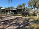 Metal barn with adjacent wooden fence and gate at 2403 County Road 416N, Lake Panasoffkee, FL 33538