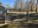 Metal gate opens to fenced pasture area at 2403 County Road 416N, Lake Panasoffkee, FL 33538