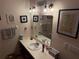 Bright bathroom with vanity, mirror, and shower at 2403 County Road 416N, Lake Panasoffkee, FL 33538