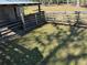 Wooden and metal cattle enclosure with a shaded area at 2403 County Road 416N, Lake Panasoffkee, FL 33538