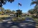 House with a circular driveway and flagpole at 2403 County Road 416N, Lake Panasoffkee, FL 33538