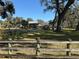 Country home with a wooden fence and large yard at 2403 County Road 416N, Lake Panasoffkee, FL 33538