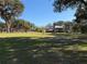 Home with a windmill and large grassy area at 2403 County Road 416N, Lake Panasoffkee, FL 33538