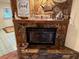 Stone fireplace with mantel and decorative accents at 2403 County Road 416N, Lake Panasoffkee, FL 33538