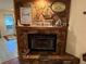 Stone fireplace with decorative mantle and artwork at 2403 County Road 416N, Lake Panasoffkee, FL 33538