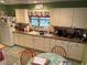 Well-equipped kitchen featuring white cabinets and granite countertops at 2403 County Road 416N, Lake Panasoffkee, FL 33538