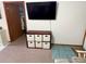 Living room with TV and storage unit at 2403 County Road 416N, Lake Panasoffkee, FL 33538