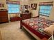 Spacious main bedroom with ample closet space and a wooden dresser at 2403 County Road 416N, Lake Panasoffkee, FL 33538