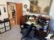 Home office with desk, laptop, and built-in shelves at 2403 County Road 416N, Lake Panasoffkee, FL 33538