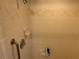 Beige tiled shower stall with grab bar at 2403 County Road 416N, Lake Panasoffkee, FL 33538