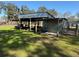Metal shed with covered workspace and tools at 2403 County Road 416N, Lake Panasoffkee, FL 33538