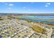 Aerial view of house and community near the lake at 2484 Lynette Ave, The Villages, FL 32163