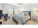 Bright bedroom with a comfortable queen-size bed and ample natural light at 2484 Lynette Ave, The Villages, FL 32163