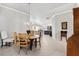 Elegant dining room with large table and view into living area at 2484 Lynette Ave, The Villages, FL 32163