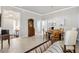 Formal dining room with round table, chandelier and hardwood floors at 2484 Lynette Ave, The Villages, FL 32163