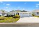 Two-story home with white exterior, gray roof and landscaping at 2484 Lynette Ave, The Villages, FL 32163