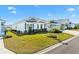 Single-story home with white exterior and lush landscaping at 2484 Lynette Ave, The Villages, FL 32163